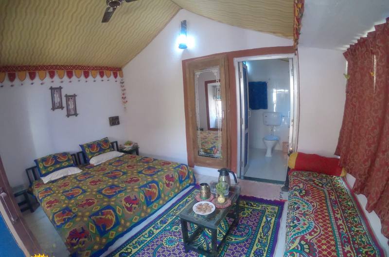 Cottage room with Rajasthani bedding and rugs