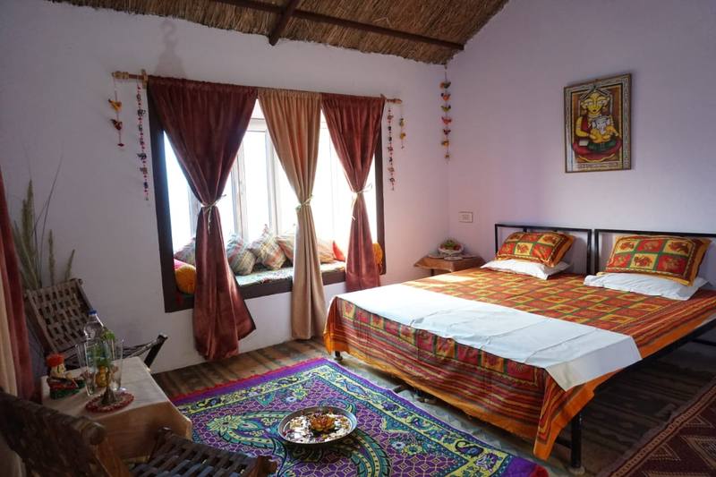 Room with window seat and handloom bedspread